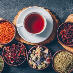 set-wood-stubs-cup-tea-tea-herbs-bowls-dark-textured-background-flat-lay (1)
